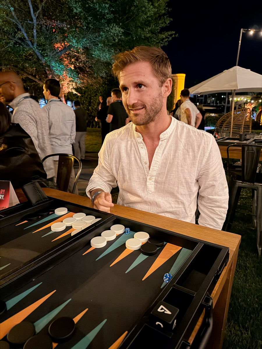 Smiling player at a Nova board during an evening match