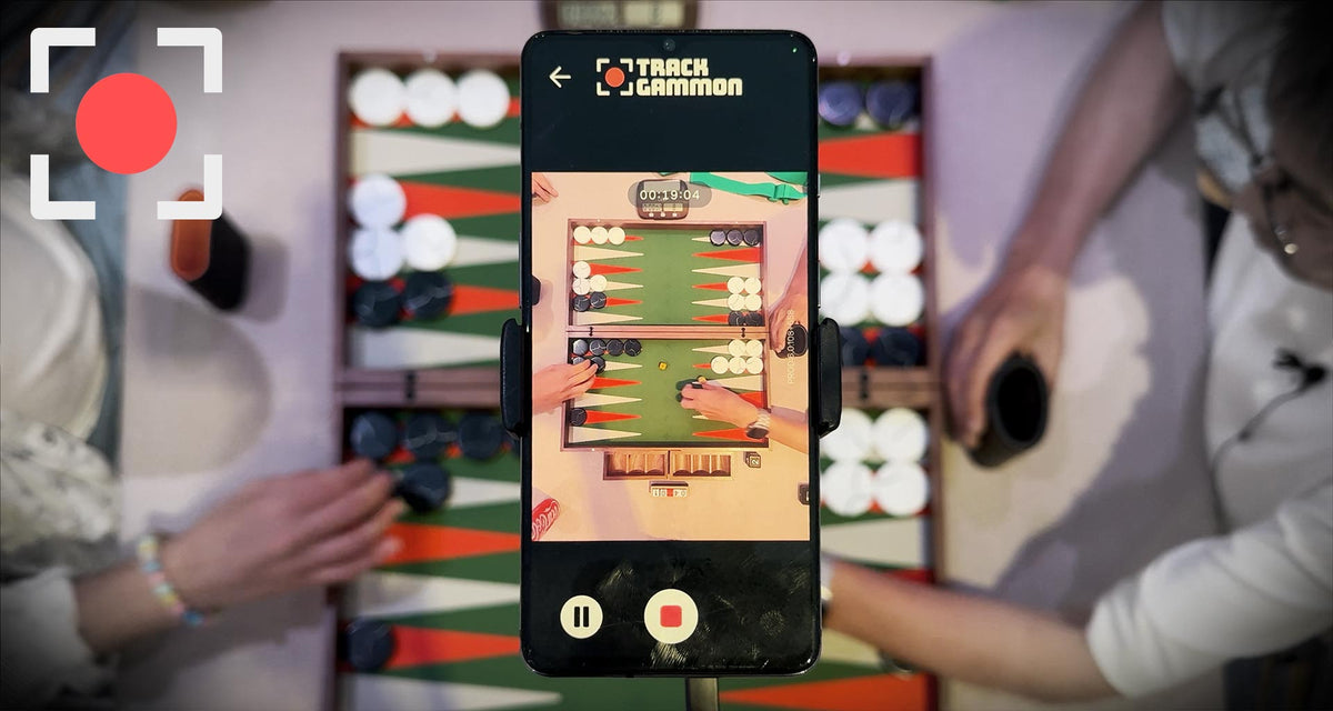 Trackgammon – phone on stand over the board, analysis on screen